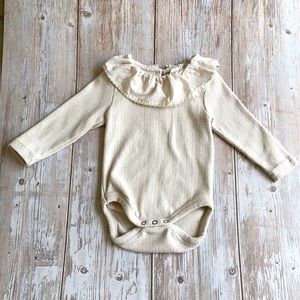 Ruffled collar onesie.